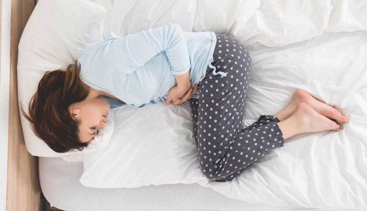 woman-with-stomach-ache-lying-in-bedCeliac-disease-1296x728222-1-1170x673